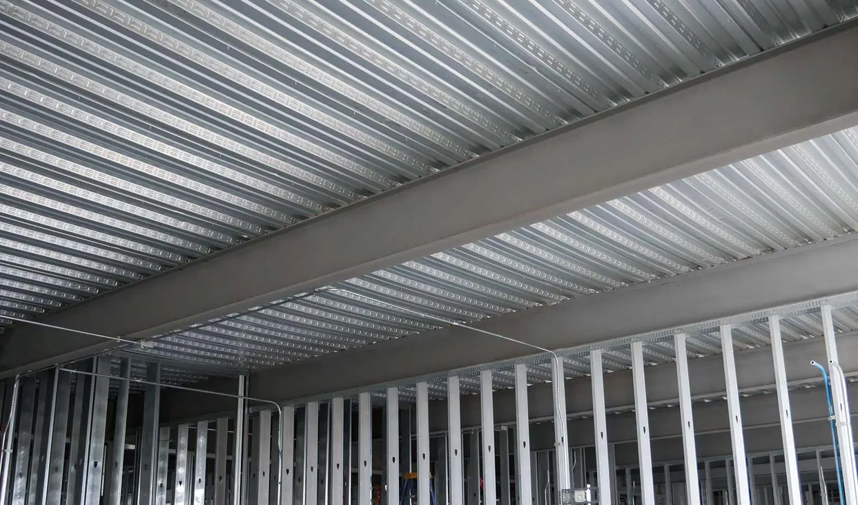 Wide photo of standard composite joists with embossments in the vertical ribs
